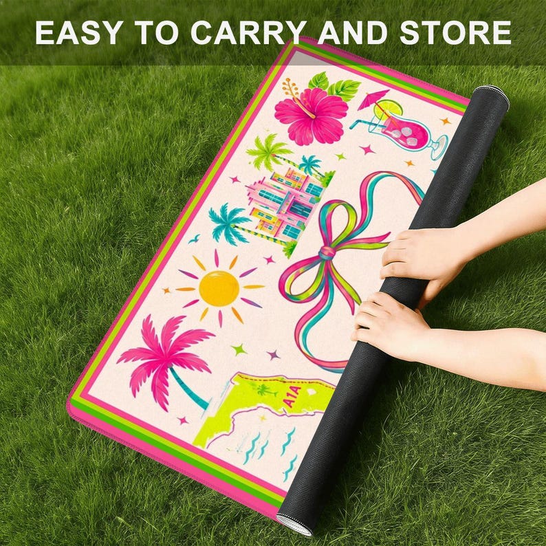 May include: A rectangular mat with a cream background and a vibrant border featuring pink, green, and yellow stripes. The surface displays colourful illustrations of a hibiscus flower, a cocktail, a sun, palm trees, a bow, and a map with the text AIA.