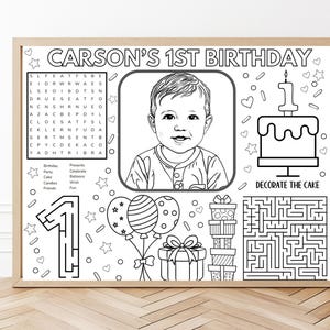 May include: A black and white colouring activity sheet titled CARSON'S 1ST BIRTHDAY featuring a central portrait of a child, a word search, a cake with the text DECORATE THE CAKE, a number one maze, balloons, gift boxes, and a square maze.