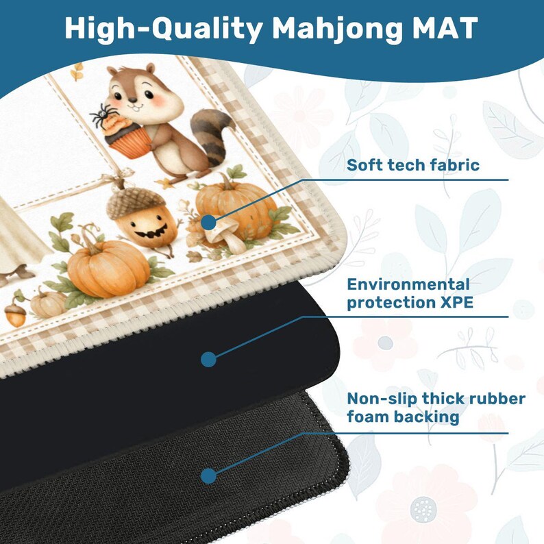 May include: A rectangular Mahjong mat featuring a fall-themed illustration of a squirrel holding a cupcake, pumpkins, and an acorn. The mat is composed of a soft tech fabric top layer, an environmental protection XPE middle, and a non-slip rubber foam backing.