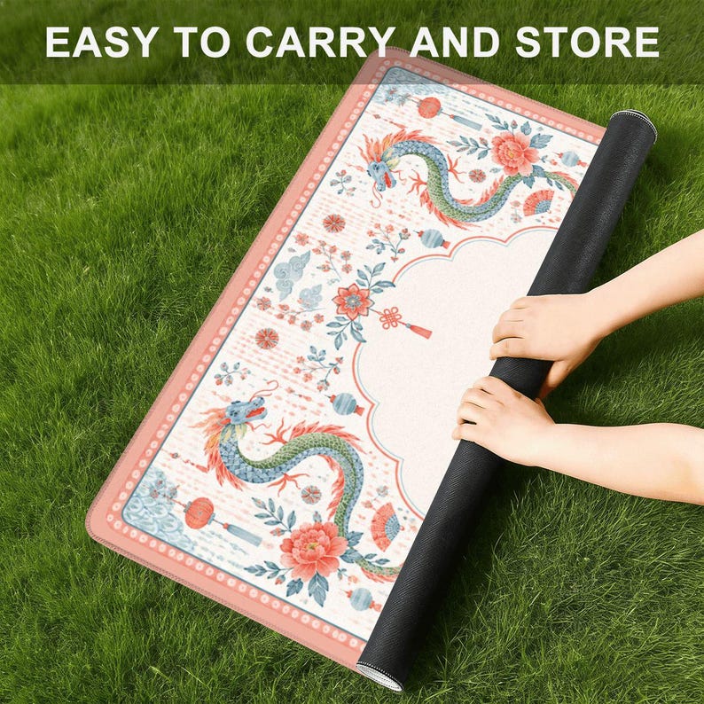 May include: A rectangular mat with a cream-colored surface featuring a repeating pattern of blue and green dragons, red flowers, and lanterns. The mat has a pink border and is being rolled up. The text "EASY TO CARRY AND STORE" is visible at the top.