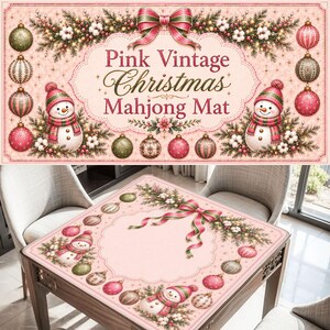 May include: A rectangular mahjong mat featuring a light pink background with a decorative border of pine branches, cotton sprigs, and Christmas ornaments. Two snowmen wearing pink hats and scarves are positioned on the mat with text.