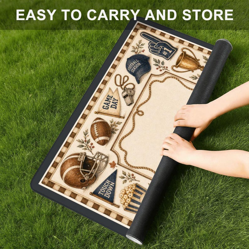 May include: A rectangular mat featuring a football-themed design with illustrations of a helmet, football, trophy, foam finger, and pennants labeled GAME DAY and TOUCH DOWN. The border is cream and brown, and the text EASY TO CARRY AND STORE is visible.