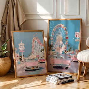 May include: Two framed art prints with a vintage Route 66 theme. One print features a roller coaster, the other a Ferris wheel, both with pink cars and a blue sky. The frames are a warm wood tone.