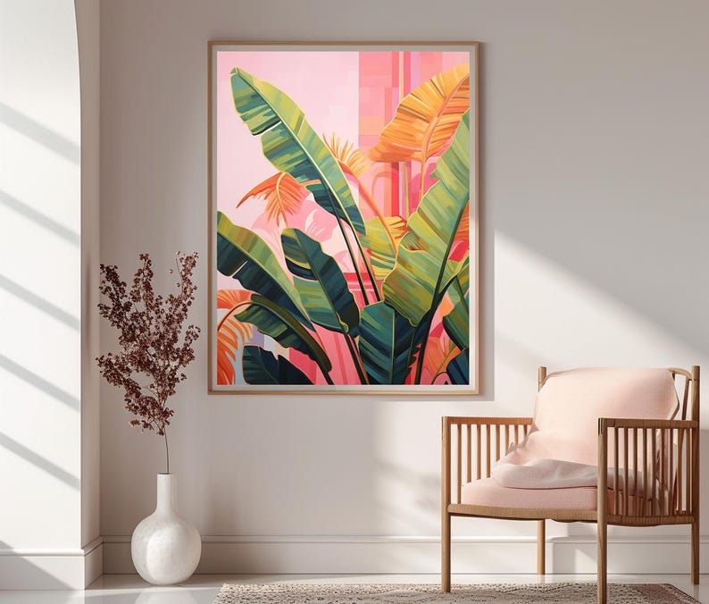 May include: A framed art print featuring a vibrant illustration of tropical banana leaves in shades of green, yellow, and orange against a pink background. The artwork is displayed in a light-colored wooden frame, adding a touch of nature-inspired decor.