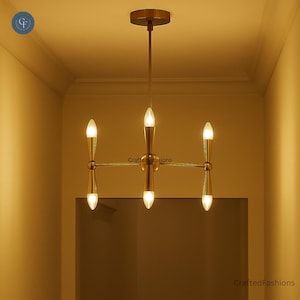 Illuminate your space with the Italian Caracas Six Light Chandelier—Mid Century Brass Sputnik design for a stylish modern touch