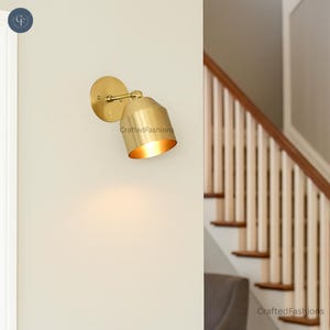 1-light cone wall sconce in raw brass—mid-century modern sputnik fixture adding sleek, vintage-inspired charm to any room or hallway