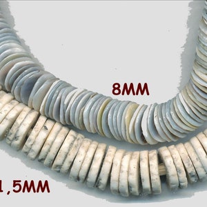 May include: Two strands of white and gray shell beads. The top strand is 8mm and the bottom strand is 11.5mm.
