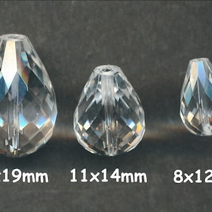 May include: Three clear glass teardrop-shaped beads with faceted surfaces. The beads are 14x19mm, 11x14mm, and 8x12mm.