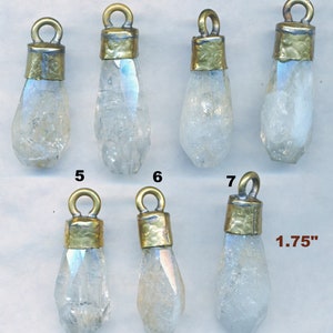 May include: Seven clear quartz crystal pendants with brass caps. The pendants are approximately 1.75 inches long.