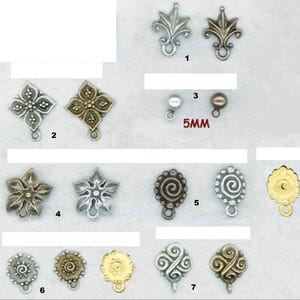 May include: A collection of metal jewelry charms in various shapes including fleur-de-lis, floral, spiral, and circular designs. The charms are finished in silver, bronze, and gold tones, with some featuring a 5mm size label next to the small beads.