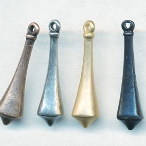 May include: Four metal bottle stoppers in different finishes: copper, silver, gold, and black.