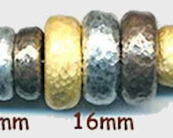 Puede incluir: Primer plano de una cadena de cuentas en tonos dorados, plateados y bronce. Las cuentas están martilladas y tienen una superficie texturizada. Las cuentas tienen un diámetro de 11 mm, 12 mm, 16 mm y 10 mm.