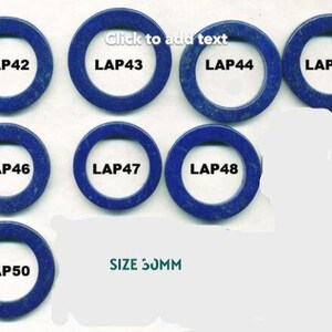 Puede incluir: Una colección de nueve anillos circulares de piedra azul oscuro, cada uno con una etiqueta blanca que muestra un código "LAP" seguido de un número. También se ve el texto "SIZE 30MM". Los anillos están dispuestos sobre una superficie blanca.