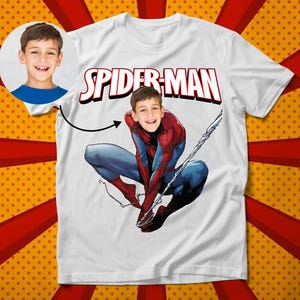 May include: White t-shirt with the words "Spider-Man" printed in red and a photo of a child's face superimposed on the face of Spider-Man.