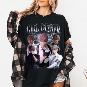 May include: Black t-shirt with a graphic print of five anime characters in a retro style. The text "GIRL DINNER" is printed in silver letters above the characters.