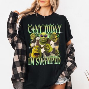 May include: Black t-shirt with a green Shrek character graphic and the text "Can't Today I'm Swamped".