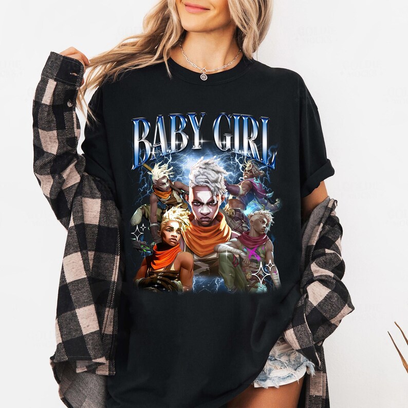 May include: Black t-shirt with a graphic print of a group of cartoon characters with the text "BABY GIRL" in a retro style.