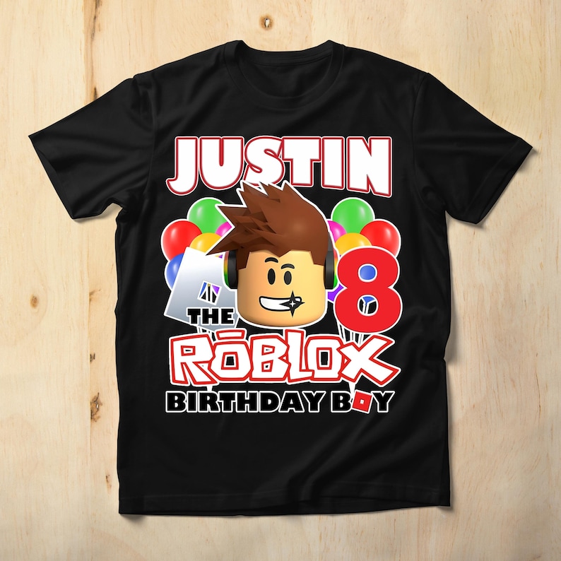 May include: Black t-shirt with a Roblox character wearing a headset and a red number 8. The text "Justin the Roblox Birthday Boy" is printed on the shirt.