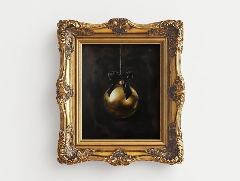 May include: A gold Christmas ornament with a black ribbon hanging from a gold ornate frame.