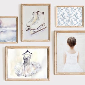 May include: Five framed watercolour art prints. The prints depict a winter landscape, ice skates, a floral pattern, a ballerina, and a ballet tutu. The frames are made of light brown wood.
