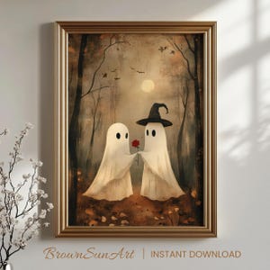 May include: A framed print featuring two ghost figures in a forest setting. One ghost is wearing a witch hat and offering a red rose to the other. The artwork has a vintage style with a warm color palette and the text "BrownSunArt | INSTANT DOWNLOAD" at the bottom.