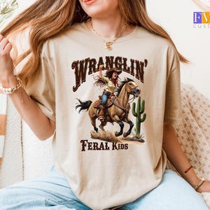 Wranglin Feral Kids T-Shirt, Western Cowgirl on Horse Tee, Rustic Country Cactus Shirt, Funny Wild West Desert Style Graphic Tee