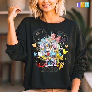 May include: Black sweatshirt with a Disney design featuring Mickey and Minnie Mouse, Donald Duck, and other characters. The design includes fireworks, a castle, and the text "Disney 2026".