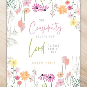 May include: A white background with a floral border. The text reads "She confidently trusts the Lord to take care of her. Psalm 112:7".