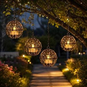 May include: Four spherical hanging lanterns suspended from a tree branch. Each lantern features a dark metal wire cage frame containing a glowing LED candle surrounded by delicate fairy lights, creating a warm, ambient illumination effect.