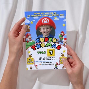 May include: A Super Mario themed birthday invitation with a photo of a child in a Mario hat. The invitation says "Power up with us as we celebrate Thomas' special day!" and includes the details: "Super Thomas Turn 7, 22 June, 301 Lurlines St, Frankston TX, Saturday, RSVP: 123-456-789".