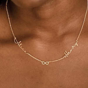 May include: A gold necklace featuring the names "Alice" and "Henry" in cursive. An infinity symbol sits between the names. The necklace is worn around the neck.