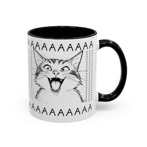 May include: White ceramic mug with a black interior and handle. The mug features a black and white illustration of a cat with an open mouth and the word "AAAAAAAAA" printed around the top and bottom.
