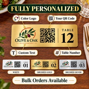 May include: A rectangular brushed gold table sign featuring the text FULLY PERSONALIZED at the top, an Olive & Oak restaurant logo, a QR code, and the text TABLE 12. Below are three smaller rectangular signs in white, brushed gold, and brushed silver.