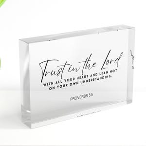May include: A clear acrylic block with the text "Trust in the Lord" in elegant script. The block also includes the scripture "With all your heart and lean not on your own understanding. Proverbs 3:5."