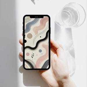 May include: A smartphone with a beige, pink, blue, and black abstract design wallpaper. The wallpaper features wavy lines, circles, and dots.