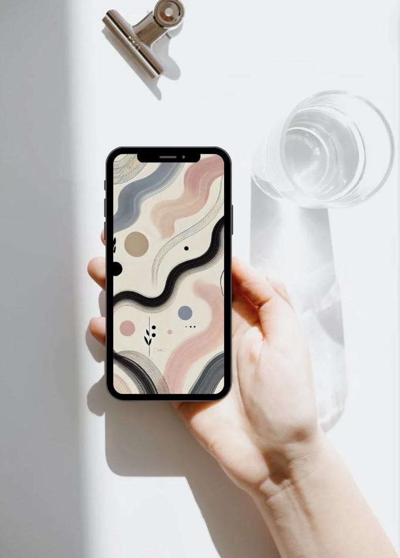 May include: A smartphone with a beige, pink, blue, and black abstract design wallpaper. The wallpaper features wavy lines, circles, and dots.
