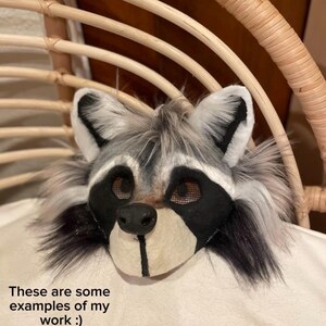 May include: A raccoon mask with black, white, and gray fur, featuring black eye coverings and a black nose. The mask is displayed on a white surface. Text on the image reads: "These are some examples of my work :)" and "Please note that I will not remake or duplicate any of them. They are not for sale!"