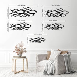 May include: Black metal wall art depicting schools of fish in various sizes. The largest piece measures 47 inches wide by 17 inches high. Other sizes include 30x10 inches, 24x8 inches, 35x12 inches, and 18x6 inches.