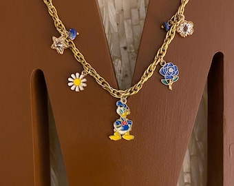 Donald inspired gold tone charm necklace with 7 charms