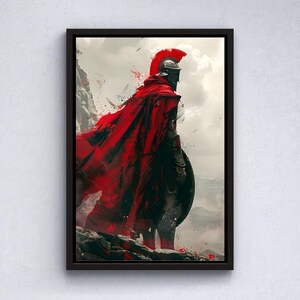 May include: A framed artwork depicts a warrior in a red cape and helmet, standing on a rocky outcrop. The artwork has a dramatic, painterly style with a focus on the figure's silhouette against a cloudy sky. The color palette is dominated by red, black, and gray.