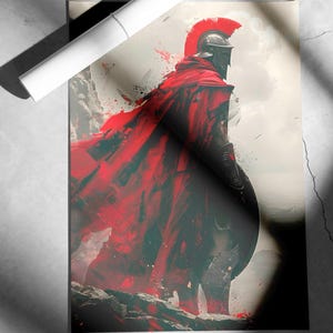 May include: An artistic print of a Spartan warrior in a red cape and helmet, standing on a rocky terrain. The artwork features a dramatic color palette of red, black, and gray, with a white rolled poster on top.