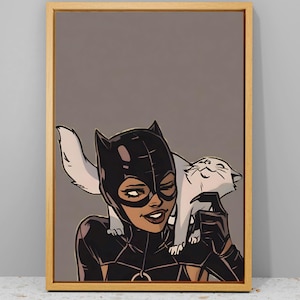 May include: A framed illustration of Catwoman in a black leather suit with a white cat on her shoulder. The background is a dark brown colour.