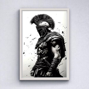 May include: Framed black and white artwork depicting a muscular warrior in ancient armour. The artwork shows a detailed illustration of a helmeted figure with a feathered crest, a cape, and a sword. The background has black paint splatters.