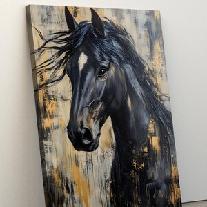 May include: A canvas print depicting a black horse's head with a white marking on its face. The artwork has a textured, abstract background with gold and neutral tones. The horse's mane is flowing. The painting is angled.