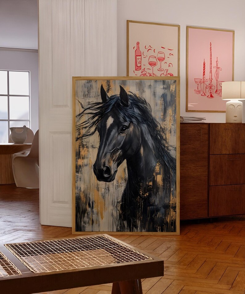 May include: A framed painting depicting a black horse with a white marking on its face. The artwork has a textured background with gold and beige hues. The horse's mane is flowing. The painting is displayed on a wooden floor.