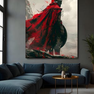 May include: A large canvas print depicts a Spartan warrior in full armor, standing on a rocky cliff. The warrior wears a red cape and helmet, holding a shield. The background features a cloudy sky and mountains.