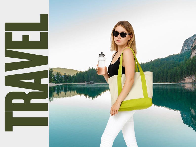 May include: A woman wearing sunglasses, a black tank top, and white pants, carries a water bottle and a cream-colored tote bag with green accents. The word "TRAVEL" is printed vertically in large, dark green letters.