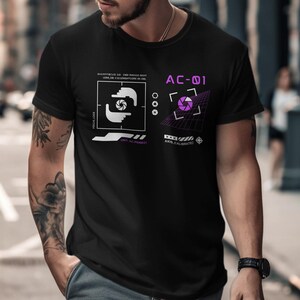May include: Black t-shirt with a graphic design featuring camera lens elements and the text "AC-01". The design includes a purple aperture and white geometric shapes. The shirt is short-sleeved.