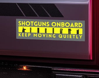 May include: A gray and yellow sticker with the text "SHOTGUNS ONBOARD KEEP MOVING QUIETLY" and a row of black silhouettes of shotguns.