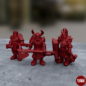 May include: Three red plastic miniature figures of warriors wearing armor and holding weapons. The figures are standing on a gray surface.